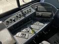 The image shows the control panel of a 2022 Blue Bird BB Conventional bus featuring multiple switches buttons and a radio in a black and gray layout