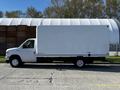 A 2019 Ford Econoline moving truck with a white box cargo area and simple design parked on a concrete surface