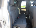 A 2014 Ford F-150 with a spacious rear seating area featuring gray fabric upholstery and a clean interior design