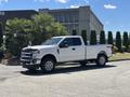 A 2020 Ford F-350 SD pickup truck in white with a crew cab and 4x4 capabilities parked on a driveway