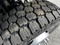 Close-up of a 2016 Ford F-550 tire showcasing its textured tread pattern and some dirt on the surface