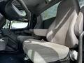 Interior view of a 2012 Freightliner M2 106 showing two gray seats with armrests in the cab area
