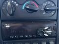 Dashboard controls and audio system of a 2018 International DuraStar featuring knobs for air conditioning and a digital display for the stereo system