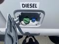 Close-up of a 2016 Ford F-350 SD fuel door showing the diesel fuel cap and its compartment
