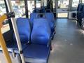 Interior of a 2020 Chevrolet Express showing blue upholstered seats arranged in rows with armrests and seatbelts