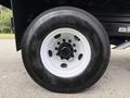 Close-up of a 2017 Ford F-750 tire showcasing a large black tire with a white rim and visible tread patterns