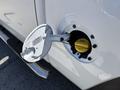 Close-up of a fuel filler cap on a 2016 GMC Sierra 1500 with the cap removed revealing the fuel inlet