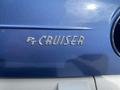 Close-up of the chrome badge on a 2007 Chrysler PT Cruiser displaying the text PT CRUISER