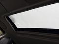 A 2016 Mitsubishi Outlander with a partially open sunroof showing rainwater droplets on the glass