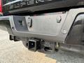 Close-up of the rear hitch and towing connectors on a 2021 Ford F-350 SD with a black finish and visible mounting points for accessories