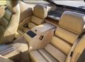 Interior of a 1983 Porsche 928 featuring two rear bucket seats with beige upholstery and a central console between them