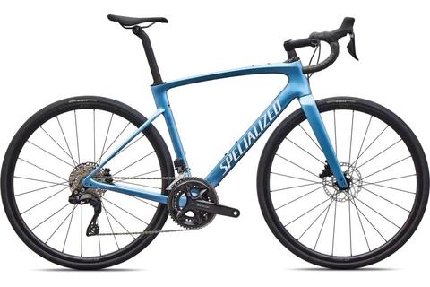 2026 Specialized Roubaix SL8 Comp Shimano 105 Di2 Road Bike in blue featuring drop handlebars and disc brakes with a lightweight frame designed for performance and comfort