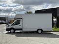 A 2016 Ford Transit box truck in white with a cargo area and a sliding side door