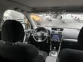 Interior of a 2016 Subaru Forester featuring a steering wheel dashboard and center console with controls and a screen