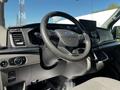 Interior of a 2022 Ford Transit featuring a steering wheel dashboard controls and a central display screen