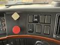 The dashboard of a 2012 Volvo VNL featuring various controls including buttons switches and gauges