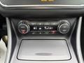 The control panel of a 2016 Mercedes-Benz GLA-250 featuring climate controls with buttons for auto mode and zone settings