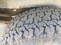 Close-up of a worn tire tread from a 2009 Ford Econoline showing distinct patterns and grooves designed for traction