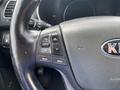 Steering wheel of a 2015 Kia Sorento featuring audio control buttons for volume mute and mode