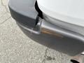 Close-up of the rear bumper of a 2010 Ford F-150 showing signs of wear and scrape marks on the dark-colored plastic surface