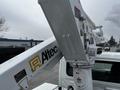 Close-up of a white crane arm and bucket with Altec branding mounted on a 2013 International DuraStar truck