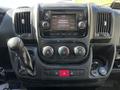 Dashboard of a 2019 RAM Promaster with a touchscreen display controls for climate and media and a gear shift lever