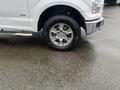 2016 Ford F-150 with a chrome wheel and rugged tire visible in the foreground