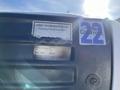 A 2005 Chevrolet Express van with visible inspection stickers and a serial number label on the driver's side door