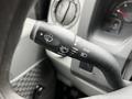Close-up of a 2009 Ford Econoline's steering column with switch controls for windshield wipers and headlights