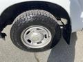 A close-up of a tire and wheel of a 2013 Ford F-250 SD showing a rugged tread pattern and silver wheel rim