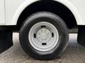 Close-up of a silver wheel and tire on a 2013 Ford F-350 SD showcasing a rugged tread pattern