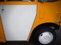 A yellow and white 2008 Freightliner MT45 Chassis with a prominent white door and a black wheel visible in the foreground