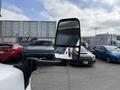 A 2020 Chevrolet Express is prominently displayed with its side mirror reflecting the driver and surrounding vehicles