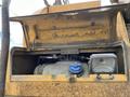The image shows the engine compartment of a 2018 John Deere 350 with a blue cap and a small light fixture visible inside the open compartment