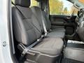 Interior view of a 2024 Chevrolet Silverado 1500 showing two front seats with seat belts and cloth upholstery