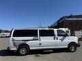 A 2007 Chevrolet Express van painted white with noticeable wear and peeling paint on the sides