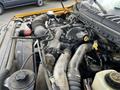 Close-up of the engine compartment of a 2017 Ford F-250 SD showing various mechanical components including hoses wires and a large air intake system