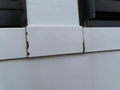 A close-up view of a 2020 Chevrolet Express showing a section with visible rust and deterioration along the edges