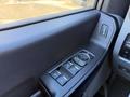 A close-up view of the window and mirror control panel of a 2024 Ford F-550 featuring buttons for adjusting windows and mirrors