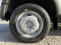 Close-up of a tire and wheel of a 2020 Ford F-550 showing a robust design with multiple lug nuts and a silver rim