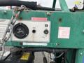 A close-up view of the control panel of a 2011 Hightliner Aquacide Hot Water Weed Control Dual Flat Deck Trailer featuring gauges switches and safety instructions