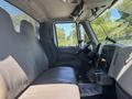 2018 International DuraStar featuring a spacious cabin with two gray seats a dashboard with controls and steering wheel visible