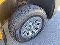 A close-up view of a tire mounted on a 2013 Chevrolet Silverado 1500 with chrome rims and visible tread patterns