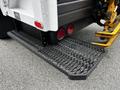 The rear step of a 2014 Hino 195 truck with textured metal surface and red tail lights visible
