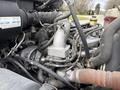 Detailed view of the engine components of a 2017 Hino 338 including various hoses and metal parts connected to the engine