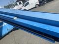 A 1997 Genie S-65 4X4 boom lift featuring a long blue extendable arm and a platform for elevated work
