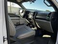 Interior of a 2018 Ford F-550 showing the driver and passenger seat with a console in between and the dashboard visible