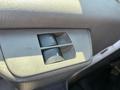 A close-up of the power window control switch in a 2014 Chevrolet Express featuring an auto function button