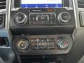 Interior dashboard controls of a 2020 Ford F-350 Super Duty featuring climate control and audio system buttons