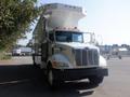 A 2008 Peterbilt PB340 truck with a large box-like cargo area and an elevated ceiling is parked with its distinctive grille and headlights visible